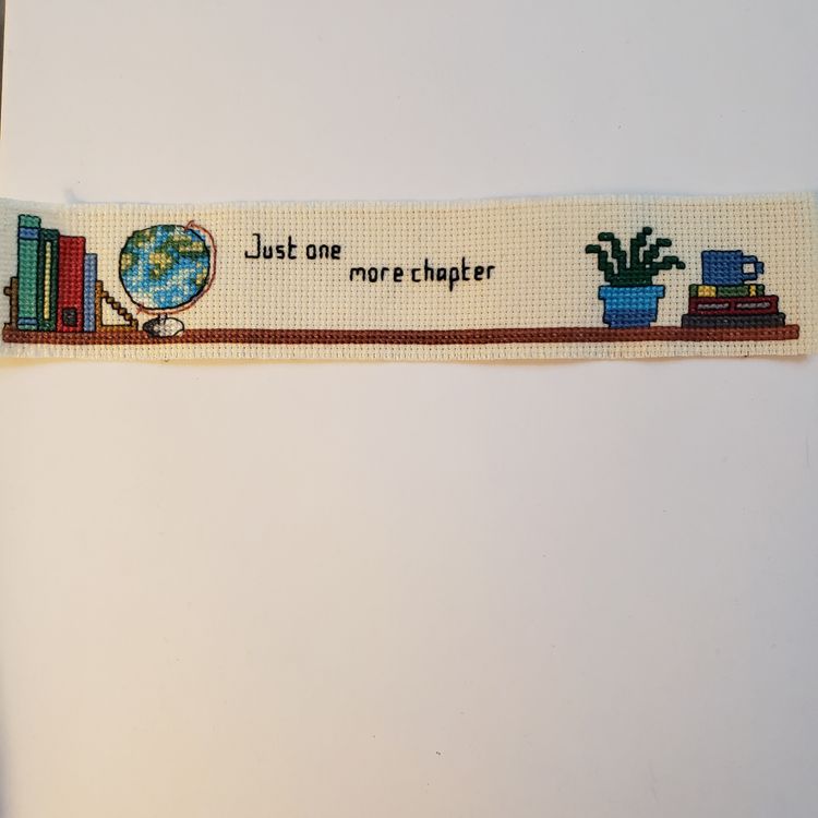 New Cross-stitched bookmark "Just One More Chapter"  on ivory Aida cloth.