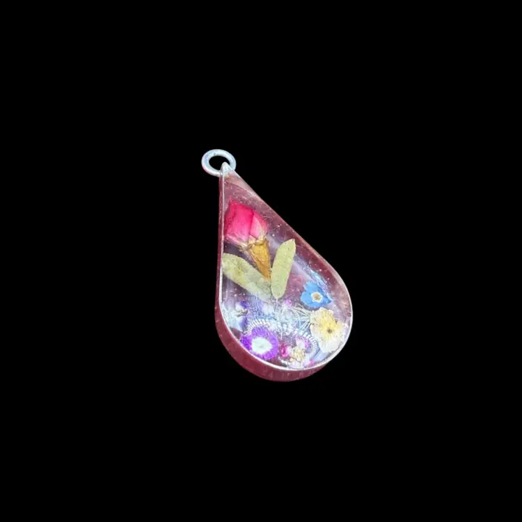 vintage sterling silver teardrop pendant containing real preserved flowers in resin