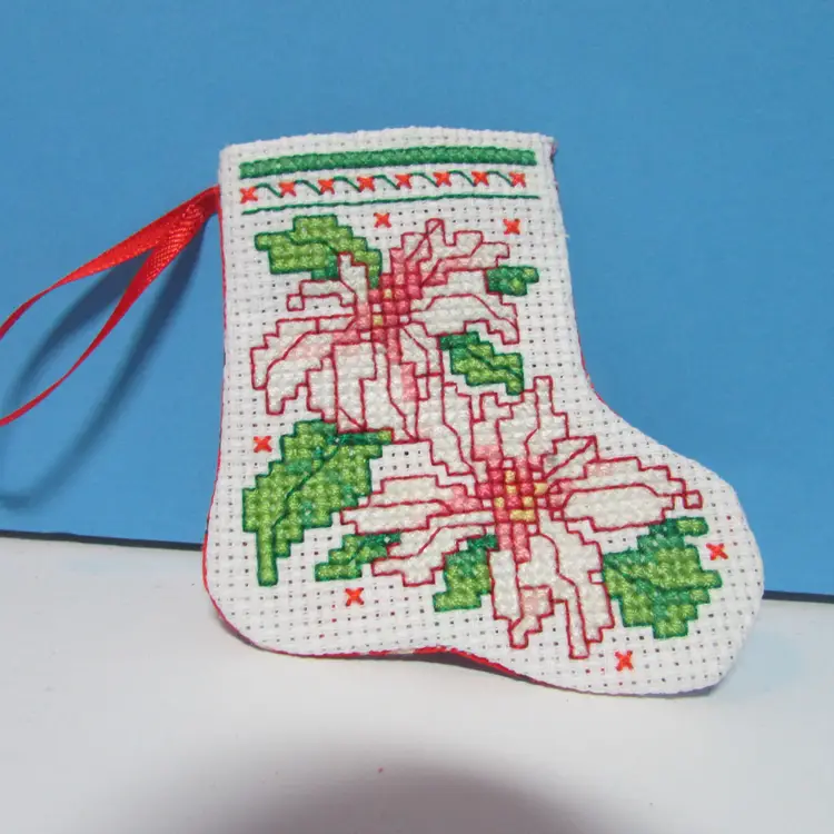 completed handmade cross stitch small Christmas stocking ornament poinsettia