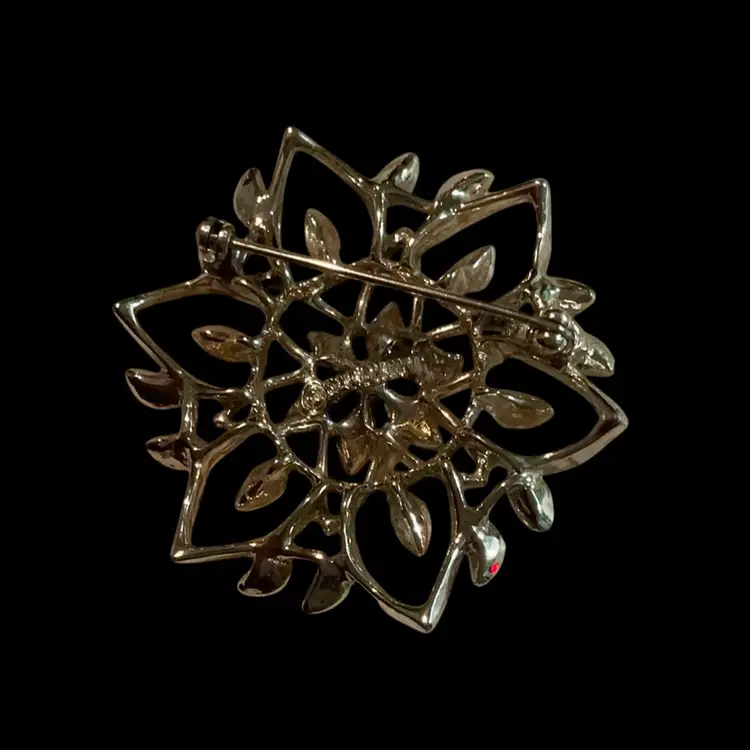 Lot Of Three Sarah Coventry Brooches. Silvertone Dove Brooch, Goldtone White Enamel She’ll Brooch, Goldtone Textured Flower Brooch.