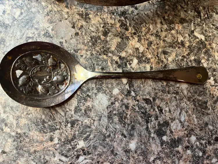 Vintage Pyrex casserole dish in a decorative silver-plated holder with Vintage Sheffield England Silver Plated Slotted Serving Spoon Acorn Design 8"