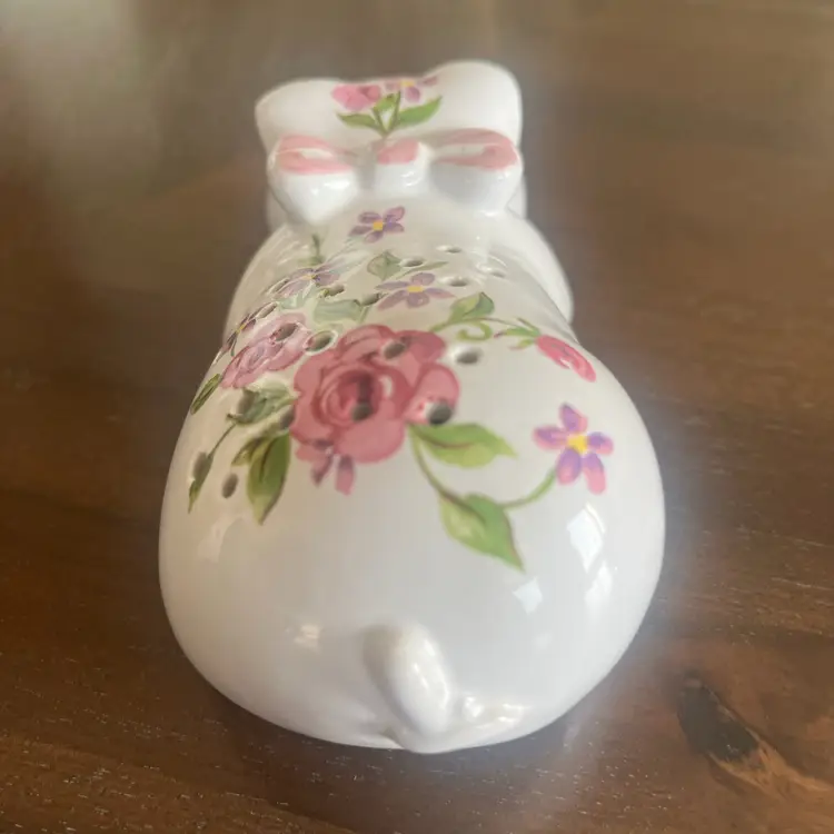 Vintage 1978 Avon ceramic sleeping pig pomander holder with floral design. 5.5” Long