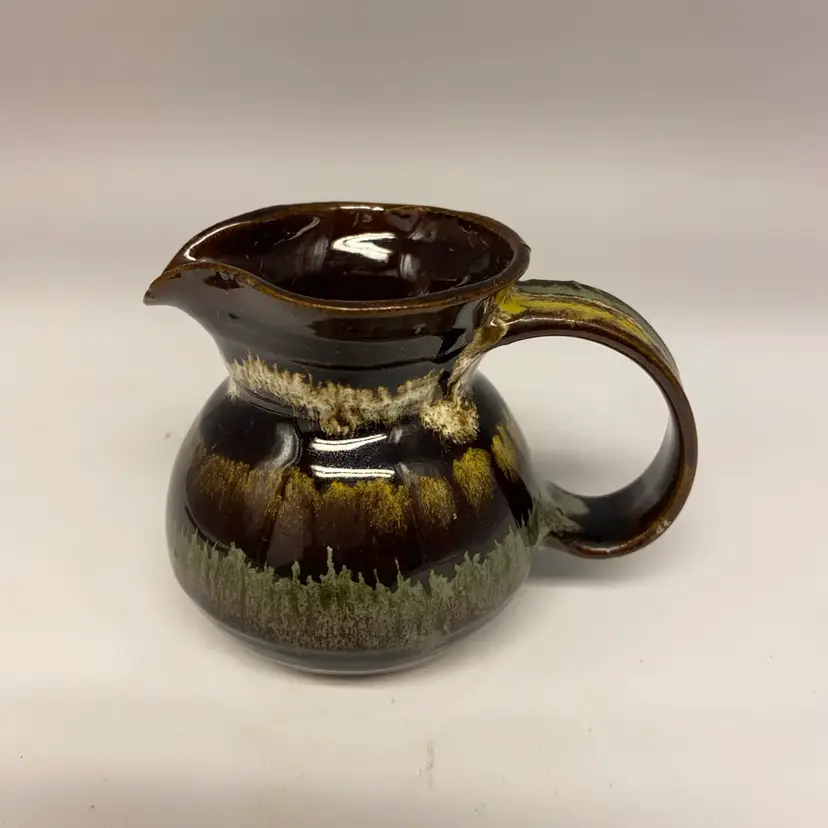 #2255 A signed Pinecroft Aylmer Canada ceramic pitcher with a drip glaze.