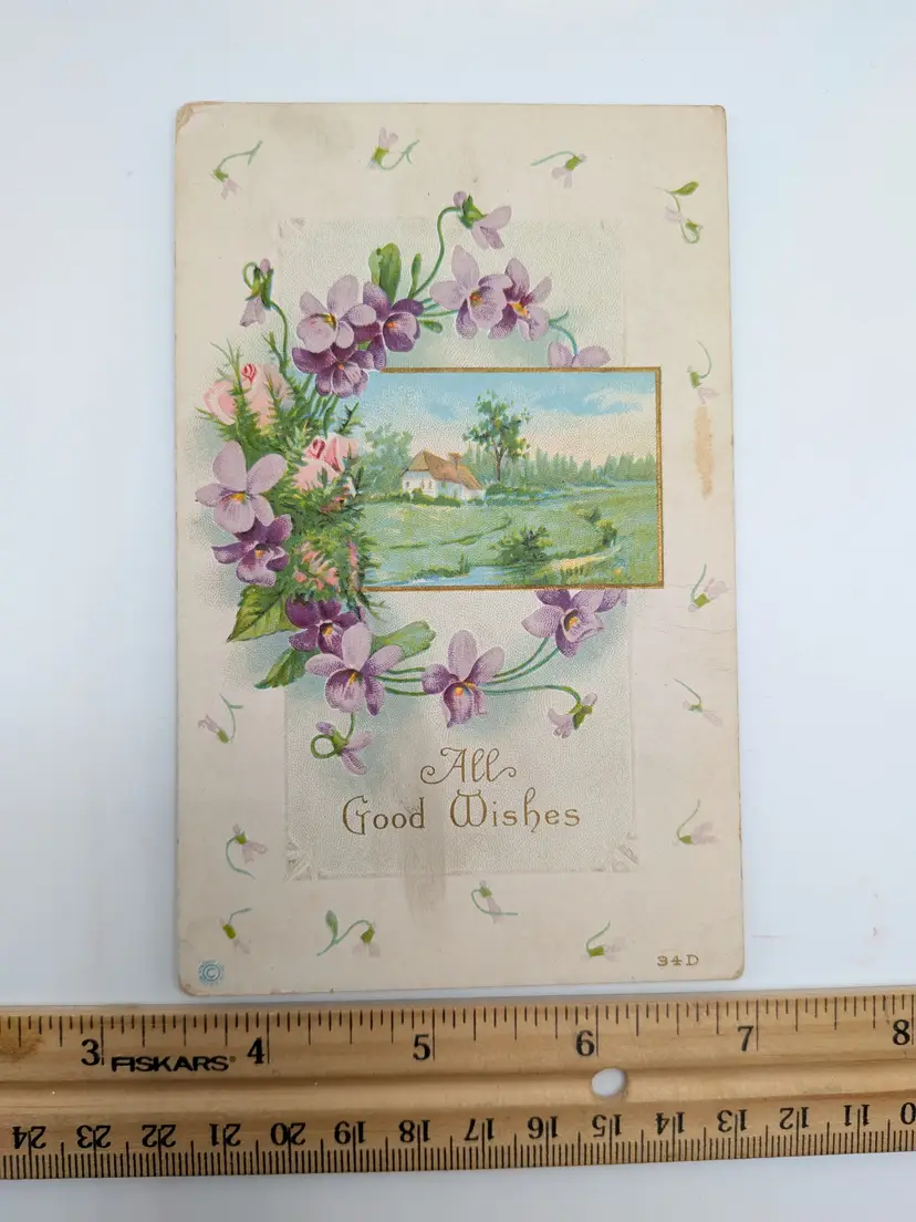 E58. ANTIQUE POSTCARD ALL GOOD WISHES PURPLE FLOWERS COTTAGE