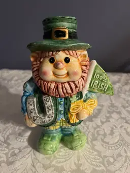 #01 A ceramic leprechaun figurine with "100% IRISH" inscription.