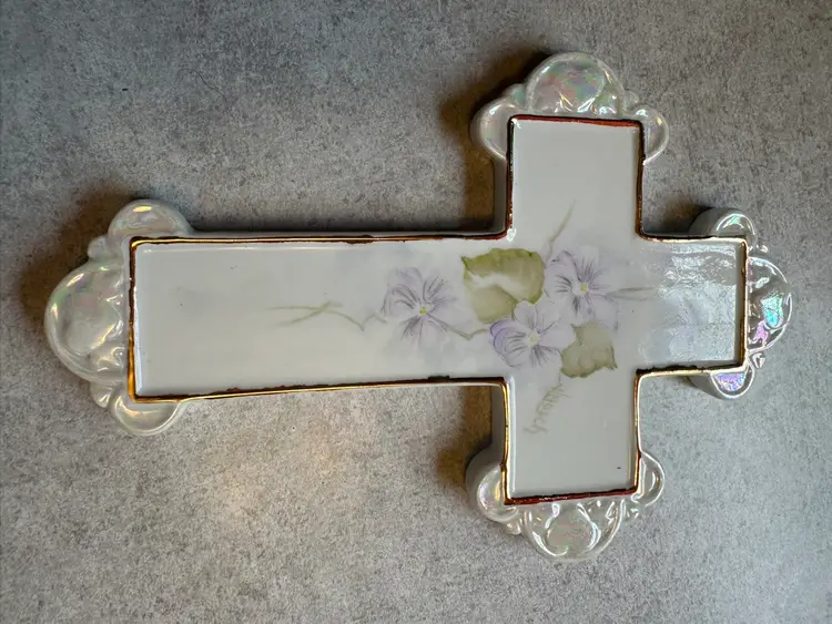 Porcelain decorative cross with hand-painted violet flowers.