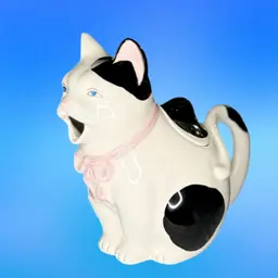 Cat Teapot Takahashi San Francisco Hand Painted  Ceramic White Black Spots Pink Bow & Blue Eyes
6 -1/2” T x 7” L x 4-1/2” W
