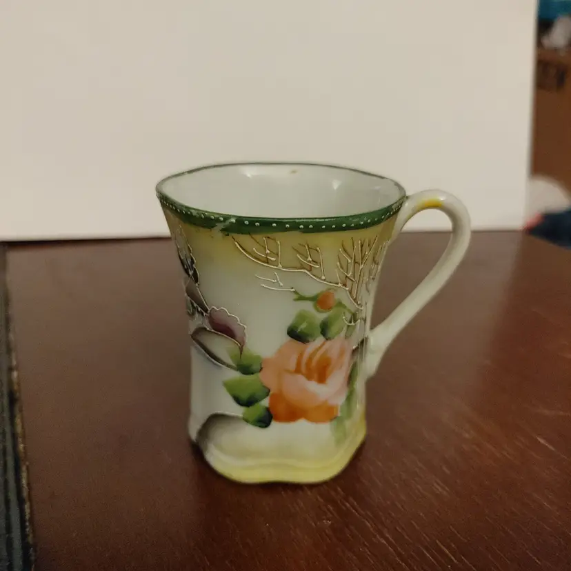 Demitasse porcelain cup with floral design. Japan 1891-1921. No chips or cracks.