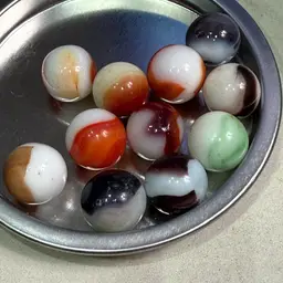 11 Milk Glass Cat’s Eyes Marbles