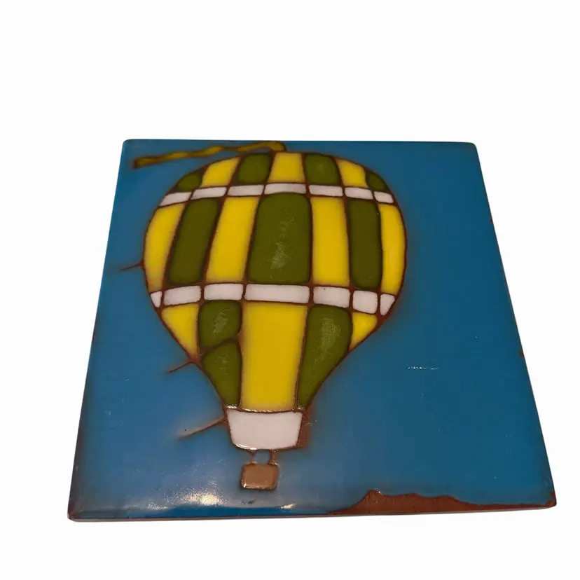 hot air balloon piece appears to be a handcrafted ceramic trivet