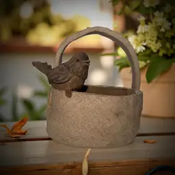 Pottery Basket With A Bird Sitting On It.