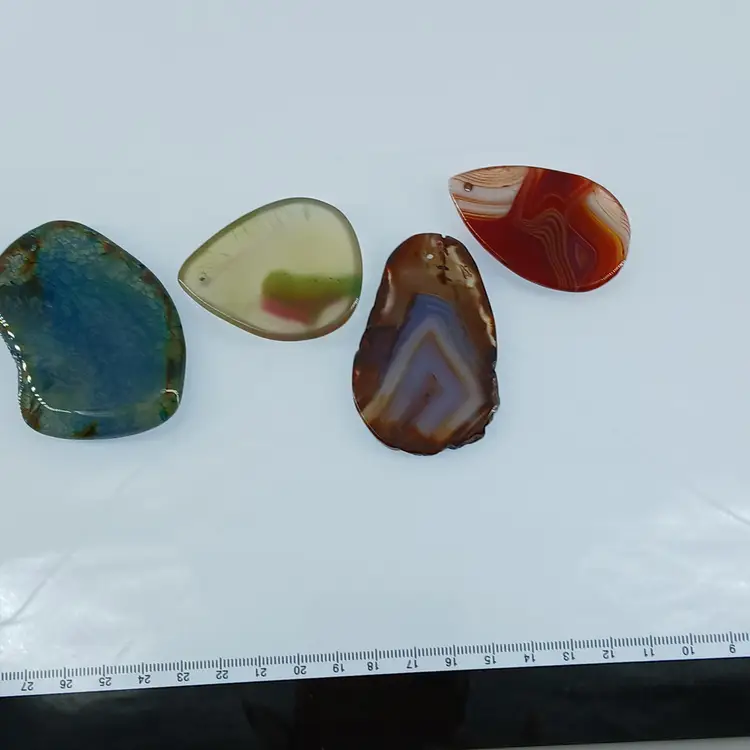 Four Polished Gemstone Pendants
