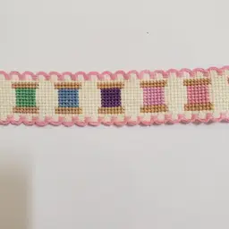 New Cross-stitched multi colored spools of thread themed Ribband ivory with pink trim.
