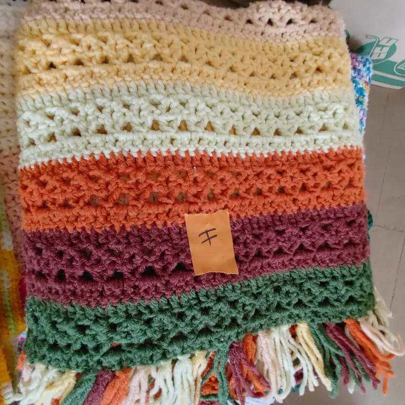 Afghan H- approx size 50 x 64. Yellow, gold, tan, green, rust & orange stripes. As shown.