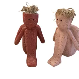 Two Figurines Of A Boy/Man Resting Head On Knees