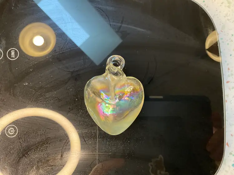 #01 Iridescent blown glass heart ornament or pendant. 3” tall and 2” wide and 1” deep.