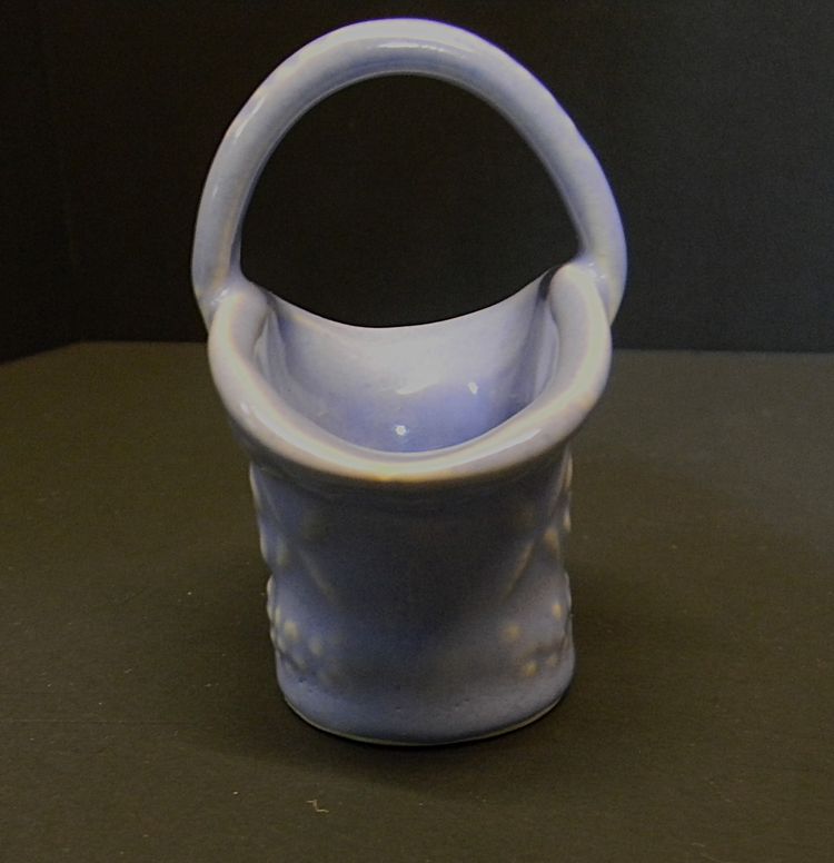 USA made little basket, blue in color, with flowers on the sides