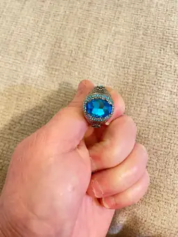 Large Size 13 Fashion Ring With A Large Blue Oval Topaz. Silver Plated. Multiple Smaller Round Topaz’s With A Filigree Design.