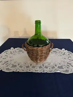 Vintage emerald green glass Demi John wine bottle with wicker basket
