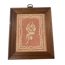 vintage framed needlepoint or cross-stitch artwork, likely featuring a rose design, which falls under the collectibles category due to its decorative and artistic nature