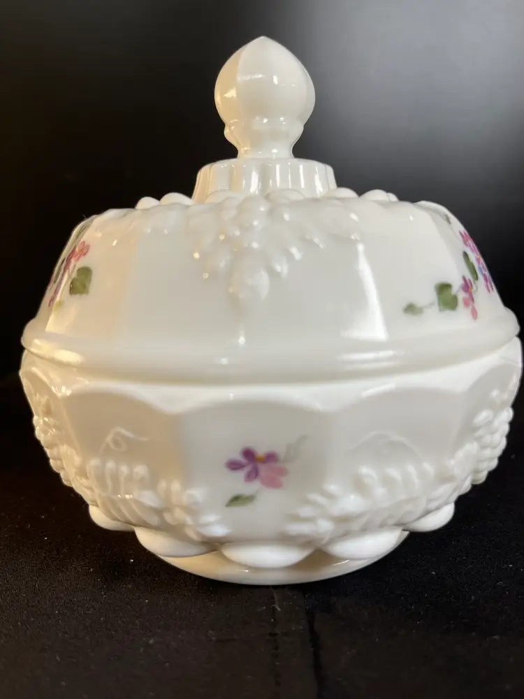 Fenton Vintage Milk Glass Covered Candy Dish w/ Paneled Grape Pattern Design. Often referred to as "Forget Me Nots" or "Violets in Snow". Hand Painted by D. Cutshaw. There is an Impressed Logo.