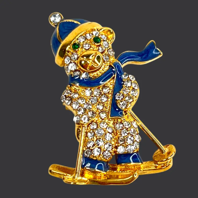 Skiing Bear with Crystal Rhinestone Body. Green Crystal Eyes. Blue Hat & Scarf. Gold-tone Brooch Pin. Marked 316L S. Steel (Stainless Steel). Great Christmas Jewelry.