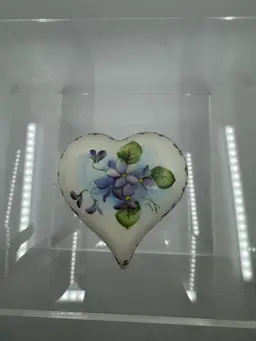 Hand-painted porcelain heart-shaped trinket box with violet floral motif.
