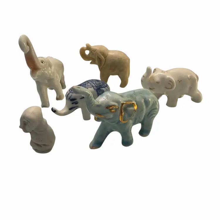 collection of vintage ceramic elephant figurines, many of which appear to be Japanese miniatures