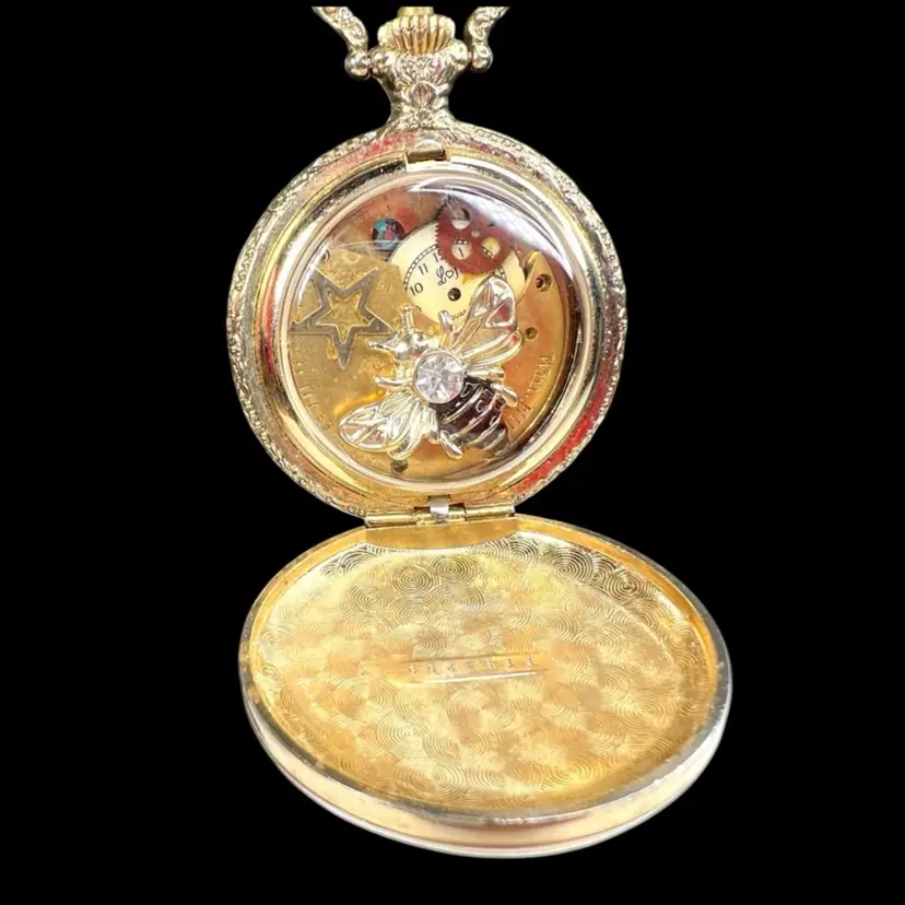Reinvented Pocket Watch (Non-Functional) with Embossed Lady Liberty / Soaring Eagle & Watch Fob Chain. Interior Assemblage- Bee Charm, Watch Parts, Gears, Swarovski Bead, Star Charm.