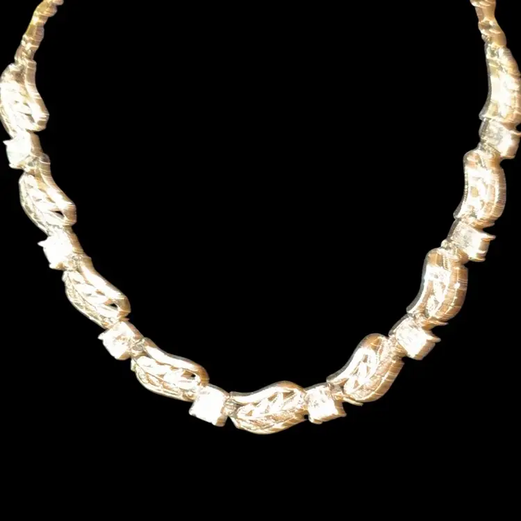 Vintage Coro gold-tone necklace with leaf motifs and clear rhinestones.