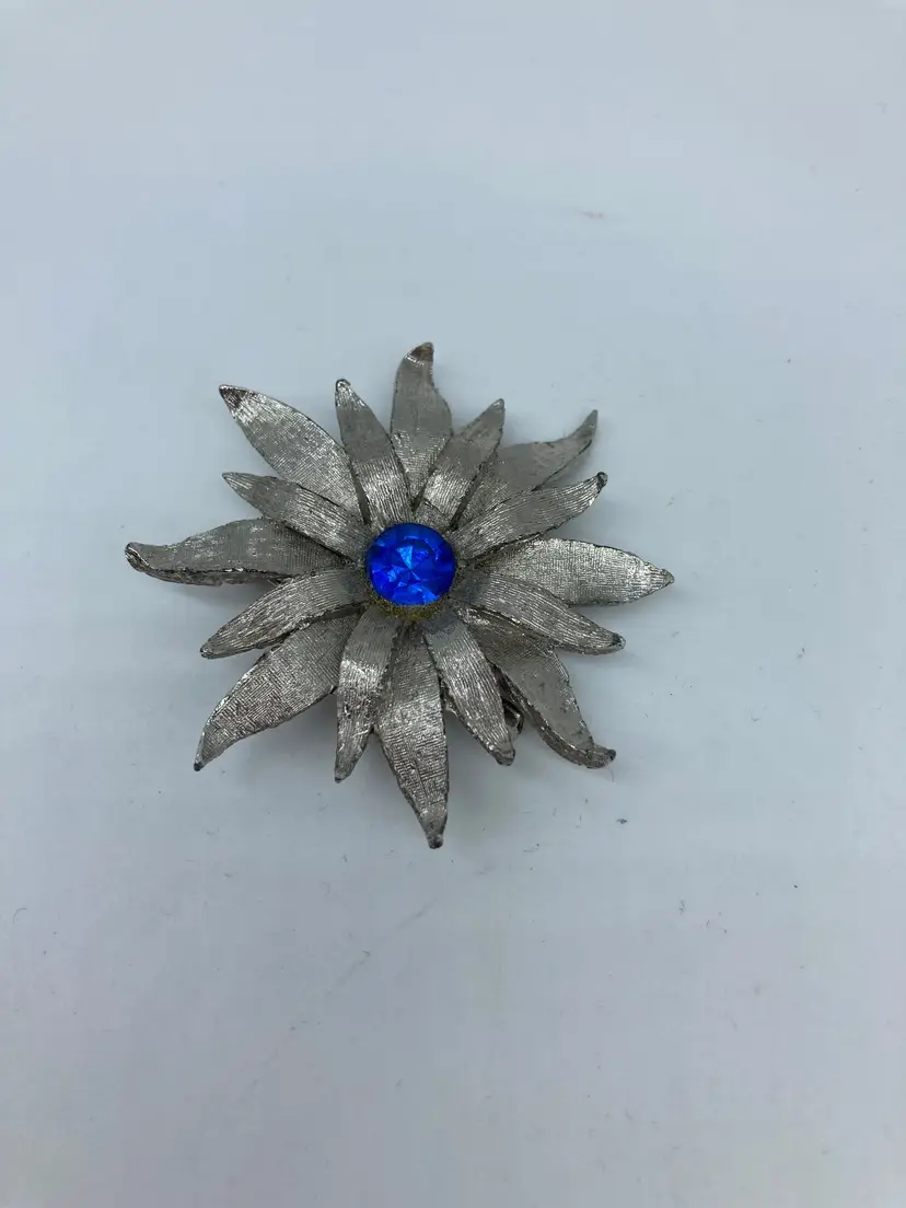 Blue rhinestone center silvertone flower brooch