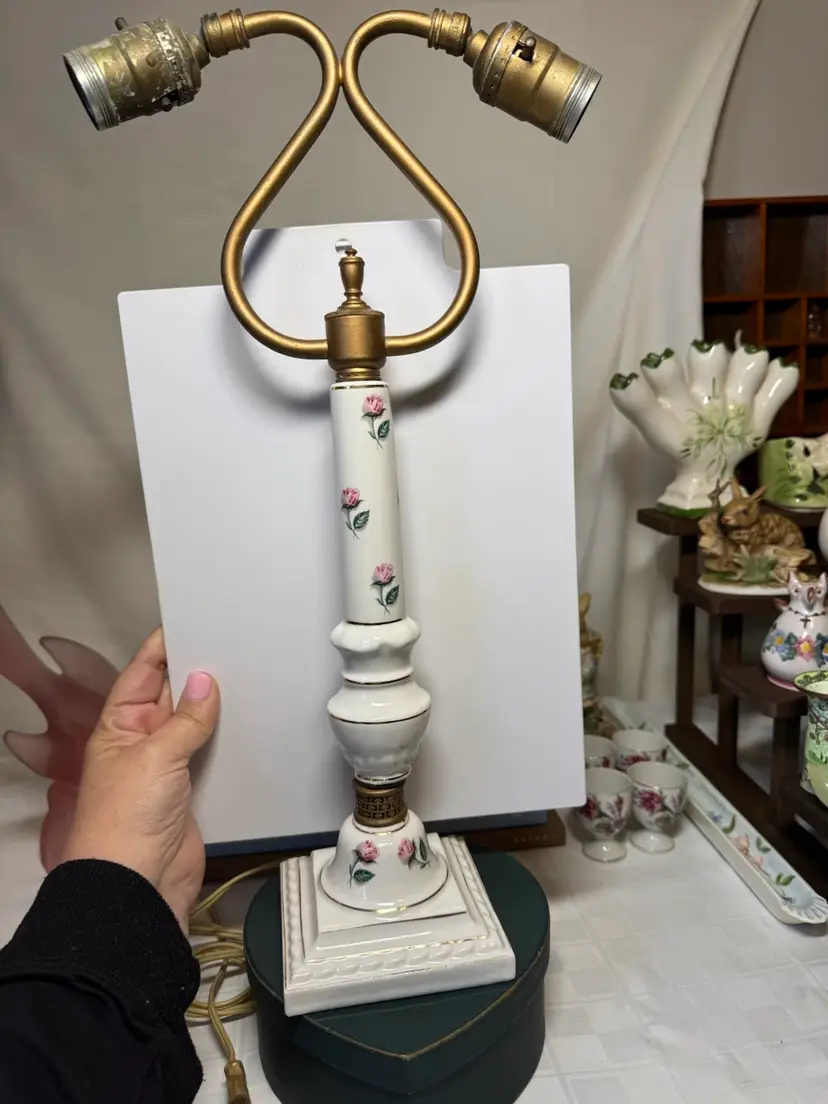 Vintage porcelain table lamp with pink roses and brass accents.