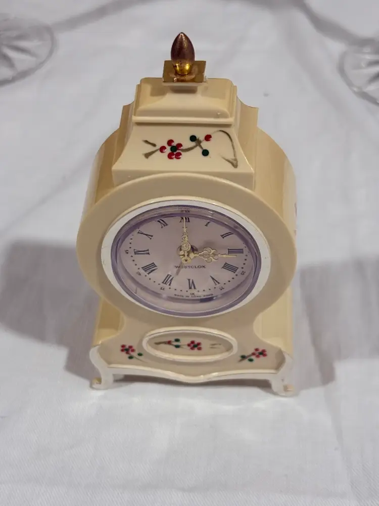 Vinntage Westclox miniature wind-up alarm clock with a hand-painted plastic