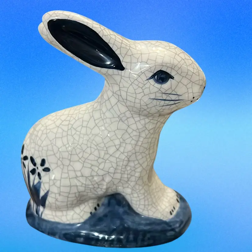 A Dedham Pottery rabbit figurine with blue crackle glaze and floral accents. Make Your Own Cotton Tail, Signed
