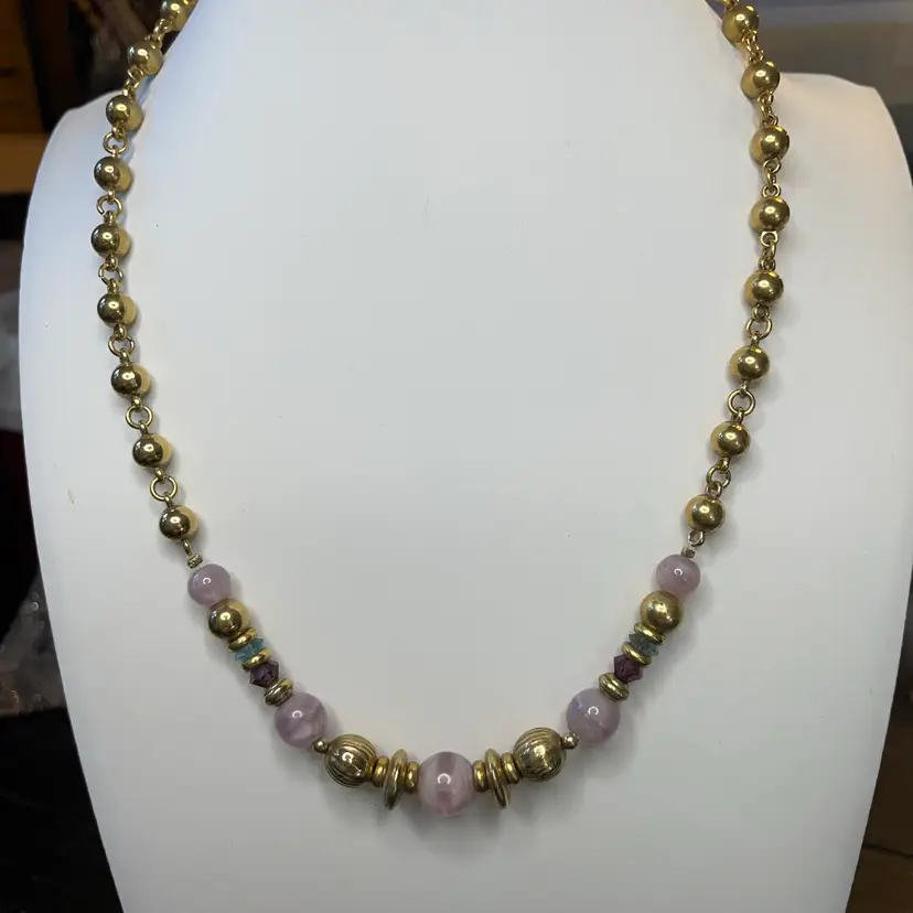 1928 brand gold-tone necklace with glass purple beads.