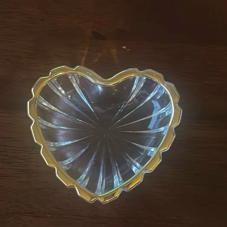 A Mikasa heart-shaped glass dish with a gold-tone rim. 3-4”