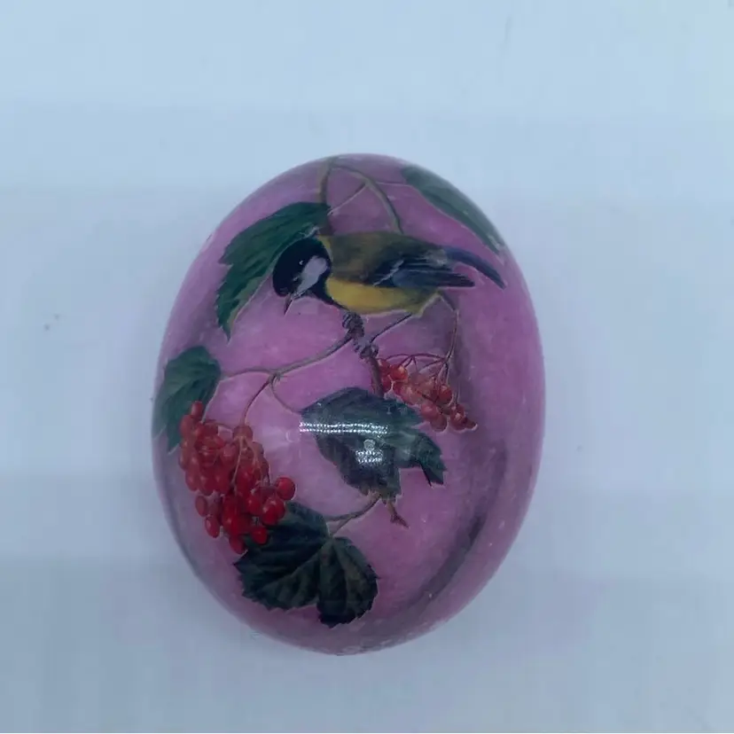 #2930 Pink alabaster egg with a painted bird and berry motif.