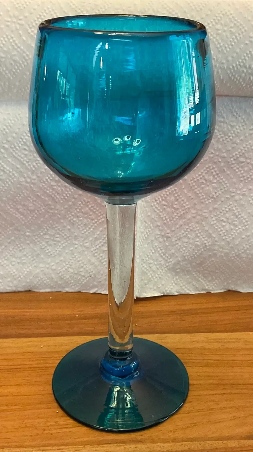 Stunning teal / turquoise stemmed glasses, hand blown. They are 8” tall and 3” across.