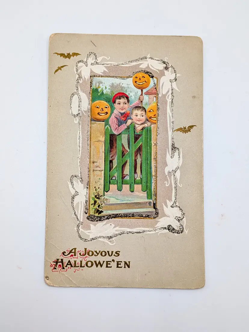 E1. ANTIQUE HALLOWEEN "A JOYOUS HALLOWE'EN" 1910 embossed Halloween postcard Tuck & Sons 345A Boys Fence Jack-o'-lantern Pumpkins Anthropomorphic