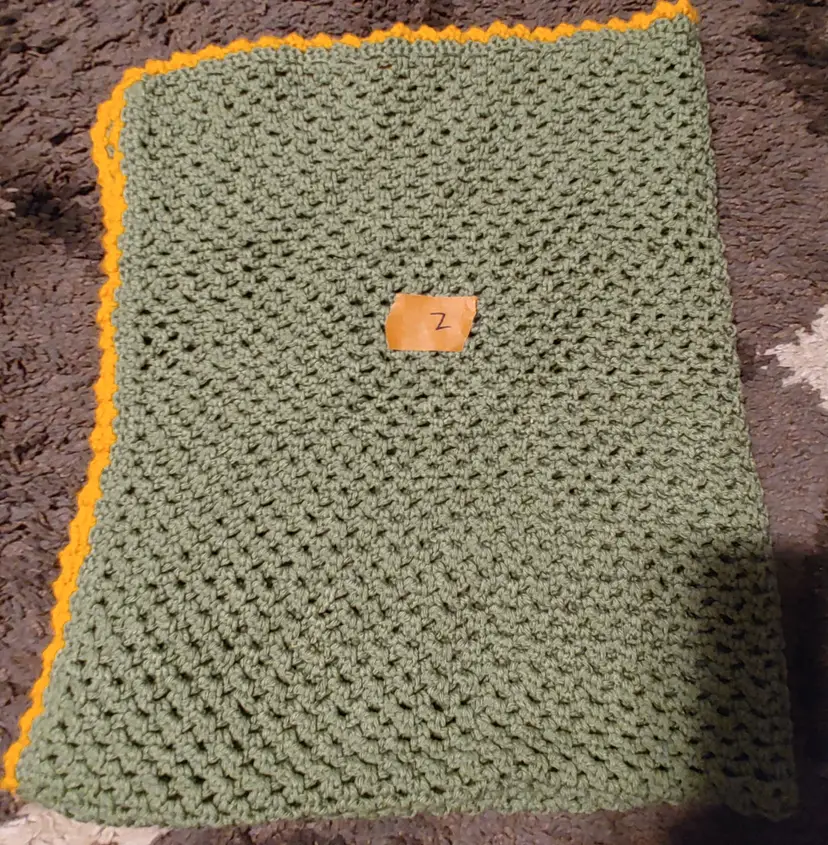 Afghan Z- approx size 31 x 38. Green with gold trim. As shown.