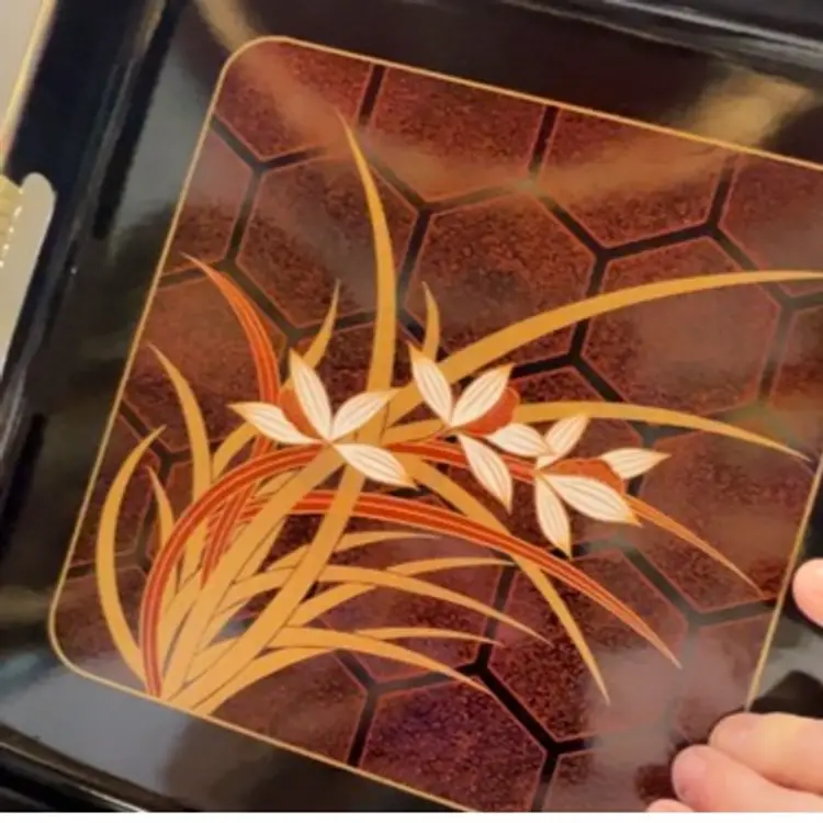 3 Piece Lacquer Ware Tray Set. Made In Japan. Tray Has Rubber Like Substance On Handles Which Looks Like Straw. Measurements Are 18 3/4”x11”, 10 5/8”x10 5/8”, 10 5/8”x7”. Has Box It Came In Looks Like Never Used.