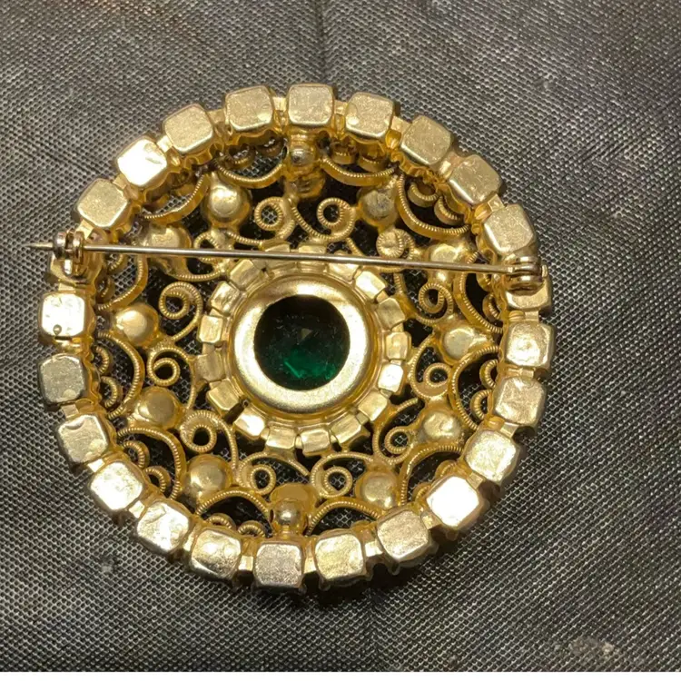 Round Brooch With Large RS In Center Which Is Circled With Gold Scroll Work And Blue/Green RS Around. Measures 2.25” In Circumference