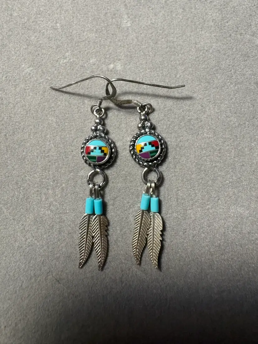 Zuni dangle earrings feature a round mosaic inlay with vibrant, colorful geometric patterns