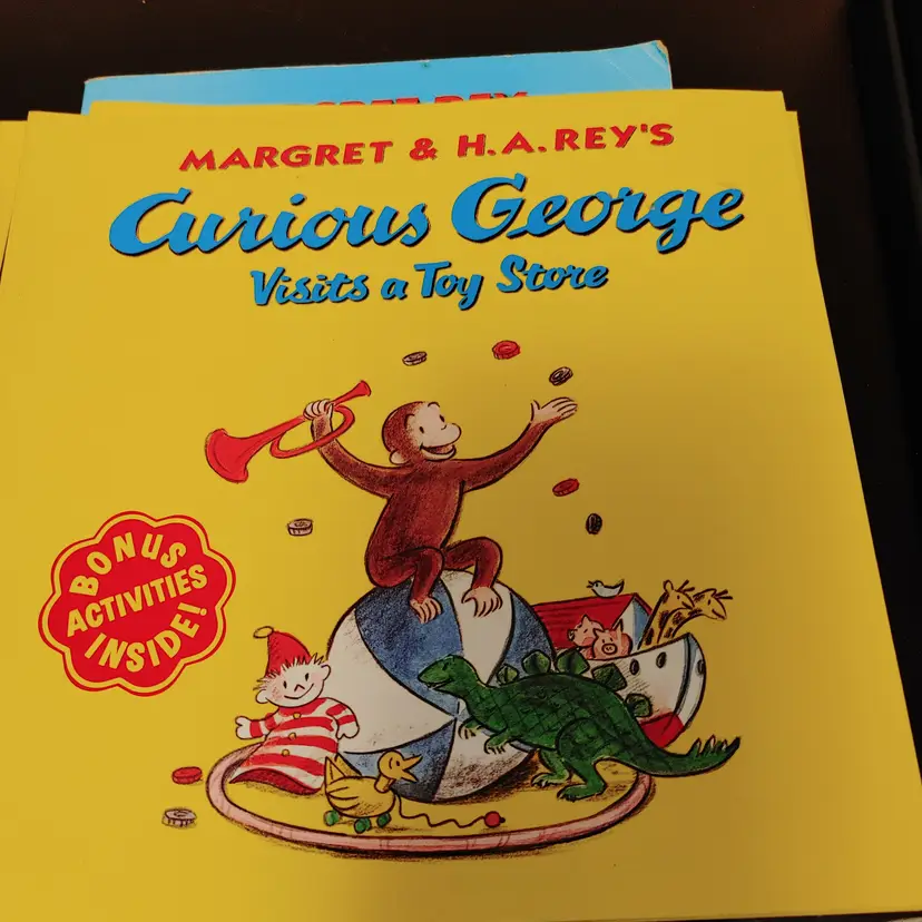 Curious George books- First Day of School and Visits a Toy Store