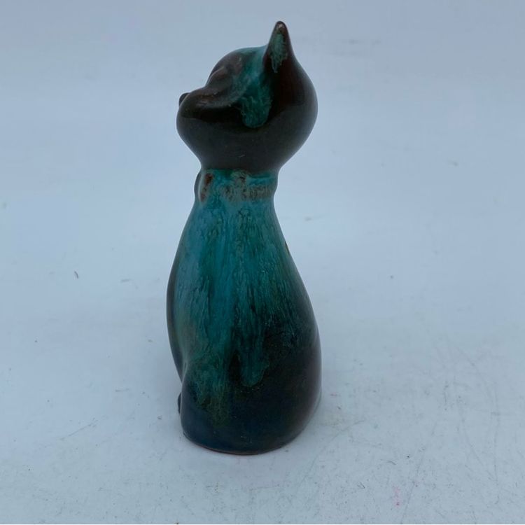 A Blue Mountain Pottery stylized cat figurine with green and black drip glaze.