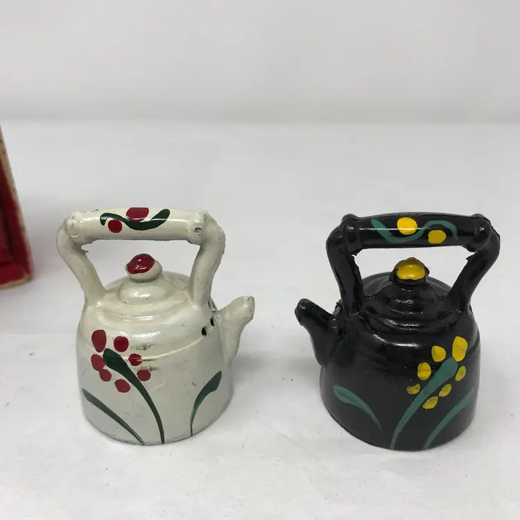 Hand-painted cast iron tea kettle salt and pepper shakers  in box with original stoppers, missing box cover. Made in USA. No makerʻs marks. 1.75 H x 2 L