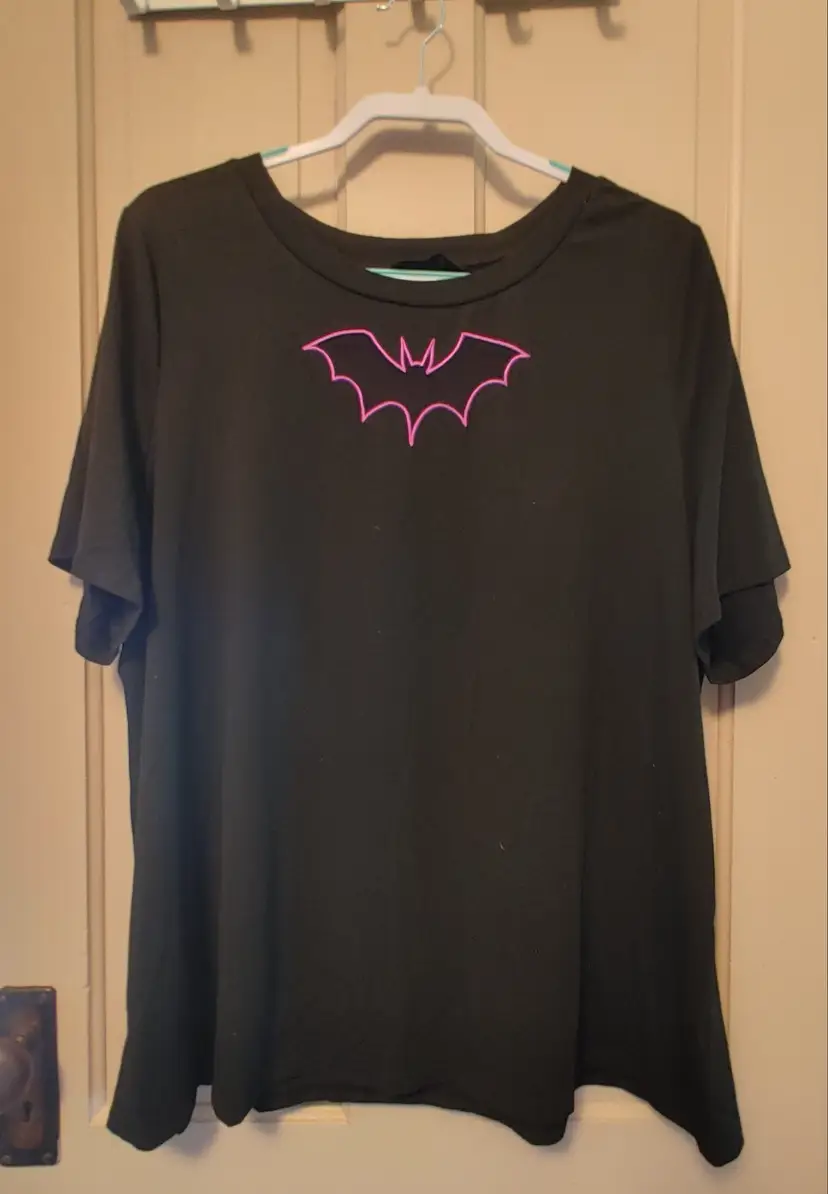 Top- Brand: Bloom Chic. Size 2X (18-20). Black top with purple bat. Material- 76% polyester, 19% rayon, 5% spandex. No callouts.