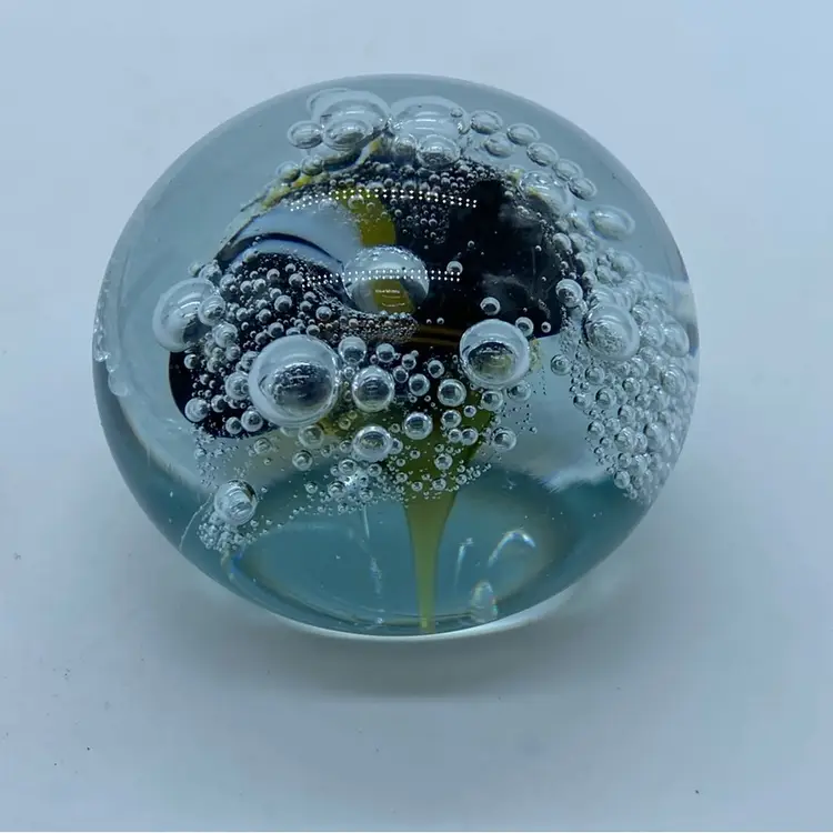 #0052 Hand-blown glass paperweight with internal bubbles and dark core.