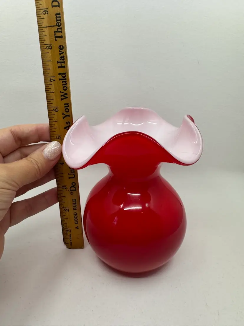 A red and white cased hand-blown art glass vase.