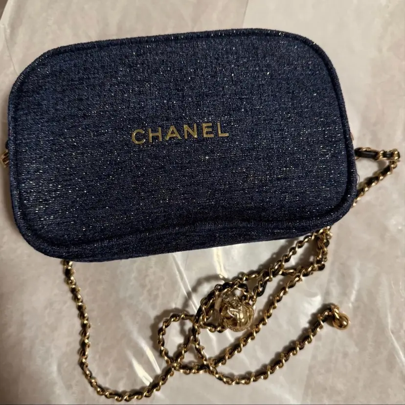 VIP Blue Chanel Beauté pouch/with an elegant gold-tone chain intertwined with blue leather